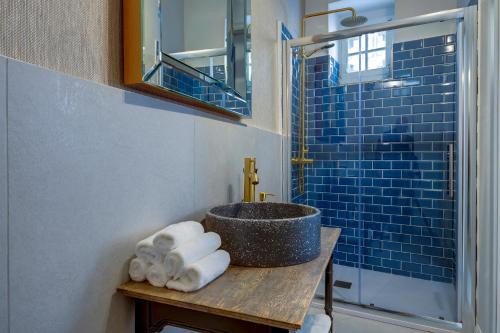 a bathroom with a sink and a counter with towels at Charming Maltese Townhouse in Senglea in Senglea