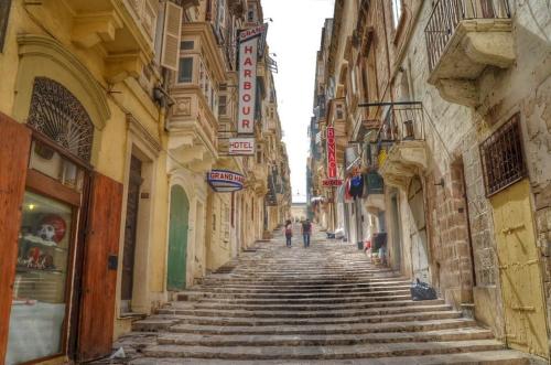 an alley with stone steps between two buildings at Charming Maltese Townhouse in Senglea in Senglea