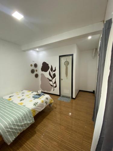 a bedroom with a bed and a hallway with a door at TopBudz Hostel Panagsama Moalboal Couple in Moalboal