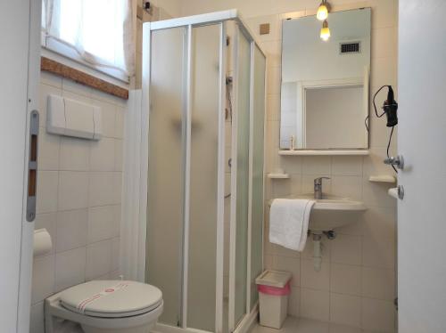a bathroom with a shower and a toilet and a sink at Bardolino Wein Apartments in Bardolino