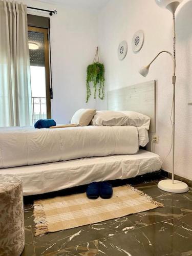 a bedroom with a bed and a lamp on a floor at el Almendral in Jaén