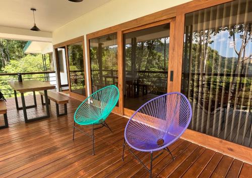 two chairs sitting on the porch of a house at Casa Kabuae in Portalón