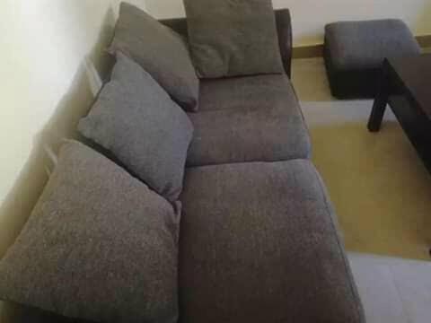 a brown couch sitting in a living room at Londoninnn in Bijilo