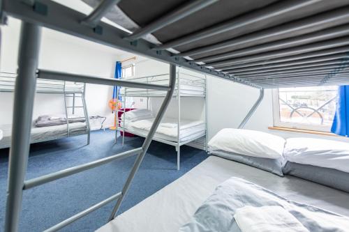 a bedroom with two bunk beds and a window at Pax Lodge in London