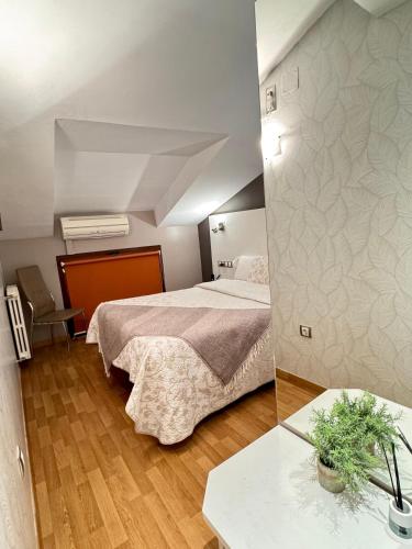 Ένα ή περισσότερα κρεβάτια σε δωμάτιο στο Hotel El Acebo