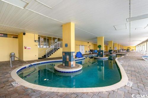 a pool in the middle of a building at Camelot By The Sea - Blue Palmetto Vacation Rentals in Myrtle Beach
