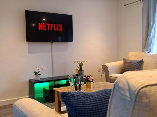 a living room with a tv on the wall at Cozy, Charming 3-Bedroom Home in Chester- Free Parking- Sleeps Up To 6 in Chester