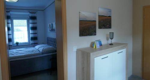 a room with a bedroom with a bed and a window at Bauernhaus Schunck im Bliesgau in Blieskastel