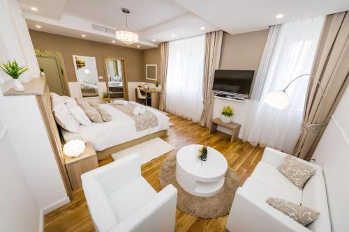 a bedroom with a bed and a living room at Peninsula Luxury Suite in Zadar