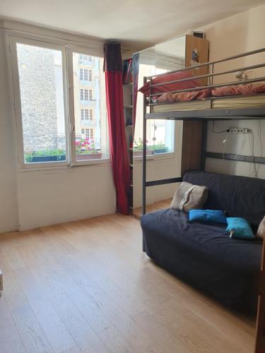 a living room with a couch and a bunk bed at Beautiful 100 m² in the Heart of Paris in Paris