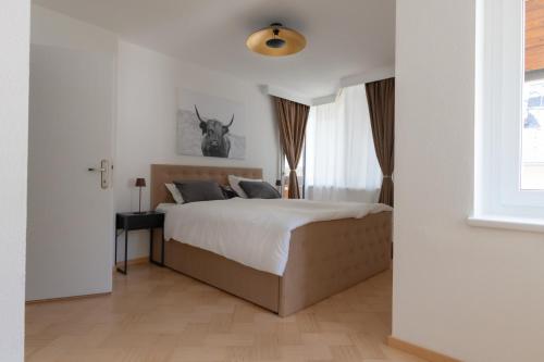 a bedroom with a bed and a deer picture on the wall at Deluxe Apartement Tirol in Landeck