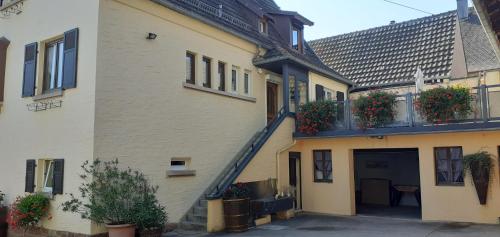 a building with flower boxes on the side of it at Les Hirondelles du MAMBOURG in Sigolsheim