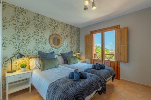 Un dormitorio con dos camas y una ventana en El Mirador de Emma, en Los Cancajos