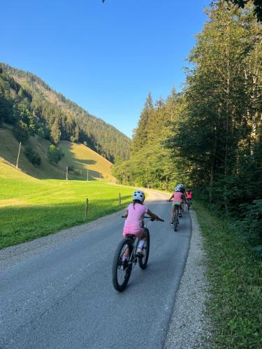 a group of people riding bikes down a road at Črjanski Raj in Črna na Koroškem