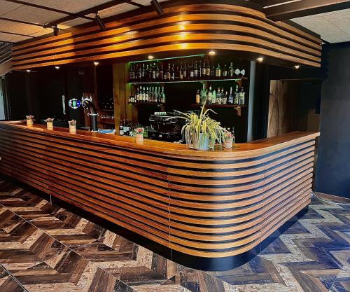 a bar with a wooden counter in a room at Best Western Amarys Hotel & Spa in Rambouillet