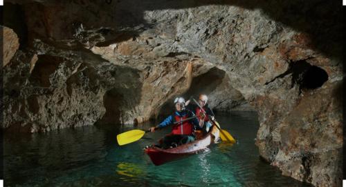 two people in a canoe in a cave at Črjanski Raj in Črna na Koroškem