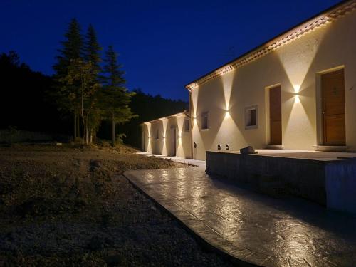 a building with lights on the side of it at night at Tenuta Barone in Duronia