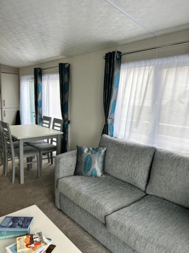 a living room with a couch and a table at Ailsa View in Lendalfoot