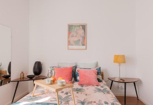 a bedroom with a bed with a table at Cozy and Stylish Room with Natural Light and Vibrant Decor in Madrid