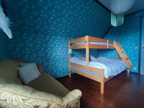 a bedroom with a bunk bed and a couch at Villaidyll i Svanesund nära havet in Svanesund