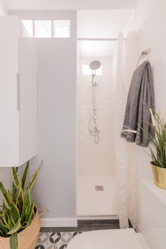 a bathroom with a shower and a toilet at Cozy and Stylish Room with Natural Light and Vibrant Decor in Madrid