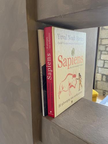 a couple of books sitting on a shelf at Delphi Gorge-view Chalet, Arachova in Arachova