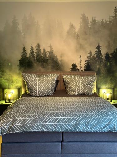 um quarto com uma cama azul e um mural da floresta em Hauptstadt Mitte em Waigolshausen