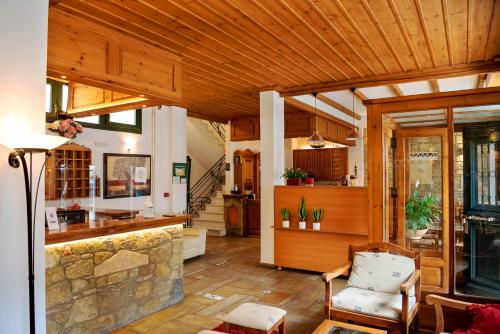 a living room with a wooden ceiling at Artemis Hotel in Delfoi