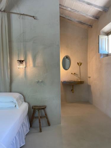 a bedroom with a bed and a sink in a room at La Saracina in Pienza