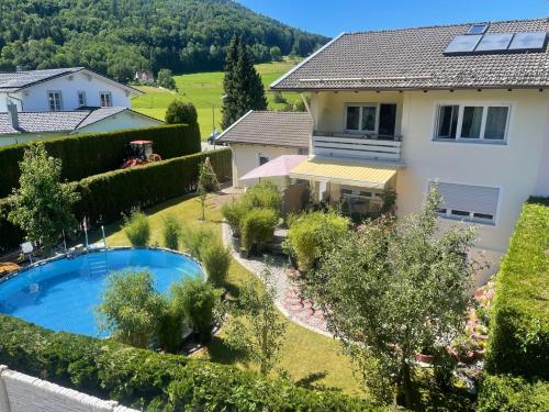 a house with a swimming pool in a yard at ciao-aschau FeWo Lexa in Aschau