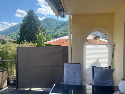 a patio with two blue pillows and a fence at ciao-aschau FeWo Lexa in Aschau