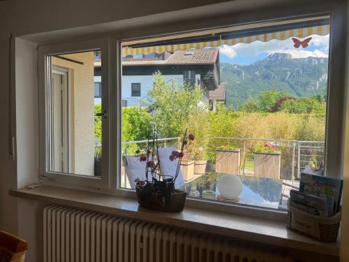 a window with a view of a balcony at ciao-aschau FeWo Lexa in Aschau