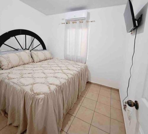 a bedroom with a bed and a television in it at casa familiar san miguel in San Miguel