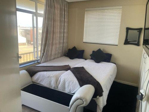 a bedroom with a large bed with a window at Kennaway Court in East London