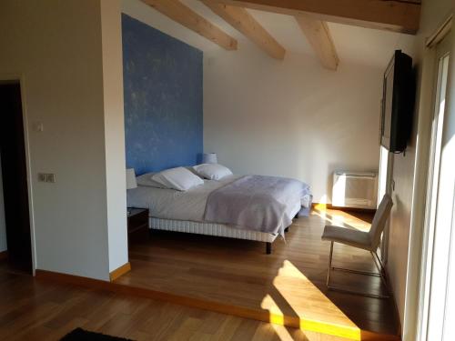 a bedroom with a bed and a flat screen tv at la grande villa in Aix-en-Provence