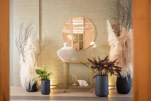 a shelf with a vase and plants on a wall at Kalamaki Beach Hotel, Zakynthos Island in Kalamaki