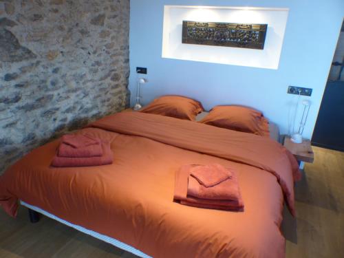 a bedroom with a bed with two towels on it at Louradou-sur-Ciel in Jouqueviel