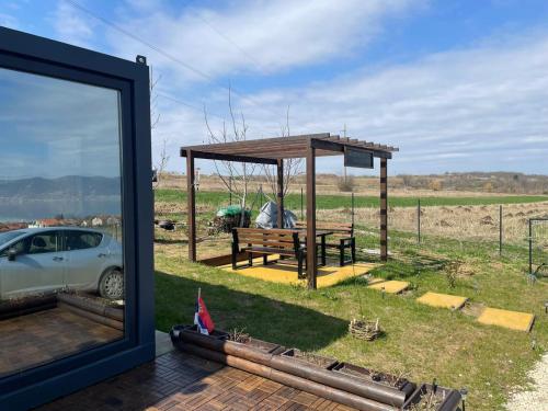a pavilion with a picnic table and a car at Od svitanja do sumraka in Golubac