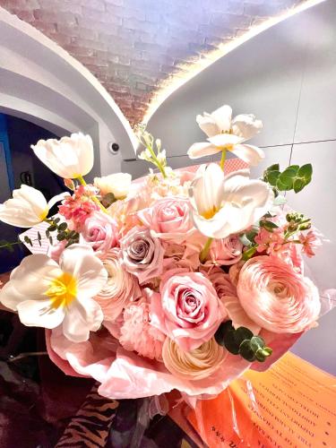 a bouquet of pink roses and white flowers at Hotel Karlin in Prague