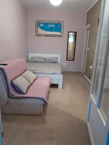 a bedroom with two beds and a window and a door at Apartmani Holiday Sutomore in Sutomore