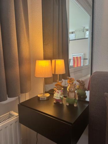 a table with two lamps and three stuffed animals on it at Stressless aktivCARD Bayerischer Wald inklusive in Sankt Englmar