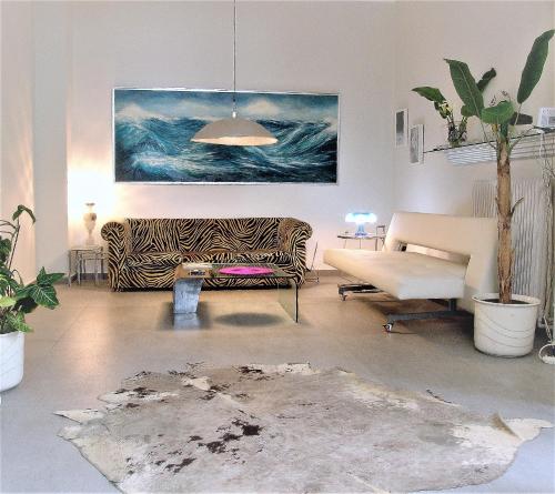 a living room with a couch and a painting at SQUARE 45 in Chania Town