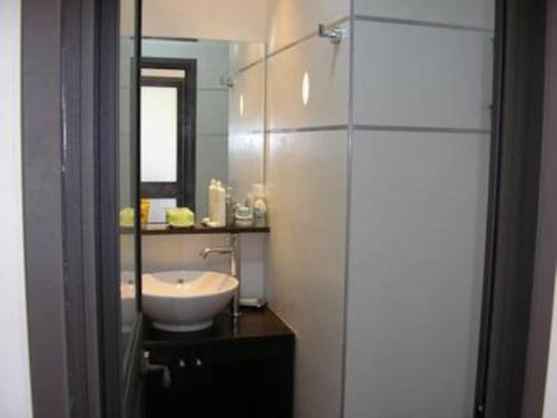 a bathroom with a sink and a mirror at Herzliya Pituach Apartment with Pool, by the Beach in Herzliya