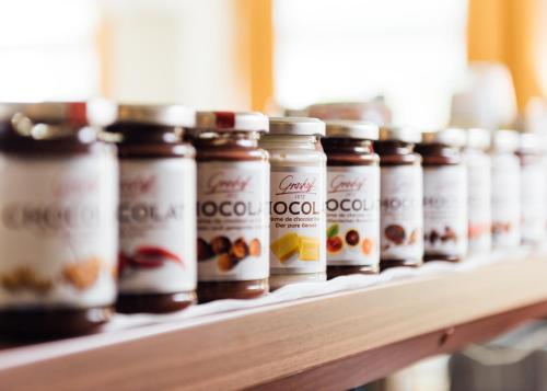 a row of bottles of coffee on a shelf at Arcade Hotel in Wuppertal