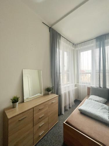 a bedroom with a dresser with a mirror on it at Room in Old Town Krakow in Kraków