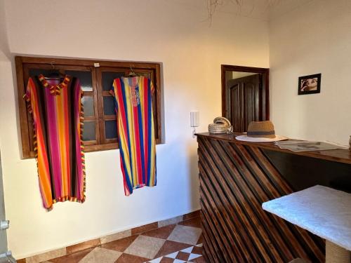 a room with colorful curtains hanging on a wall at DAR SANAE SURF in Aourir