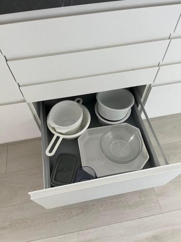 a drawer in a kitchen with plates and pans at Casa House of Bricks 2 - LEGOLAND 650m in Billund