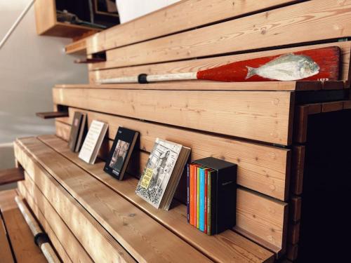 a wooden shelf with books and a baseball bat on it at Cabanon Le Perchoir des Goudes in Marseille
