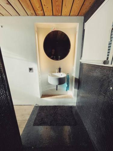 une salle de bain avec un lavabo et un miroir dans l'établissement Cabanon Le Perchoir des Goudes, à Marseille