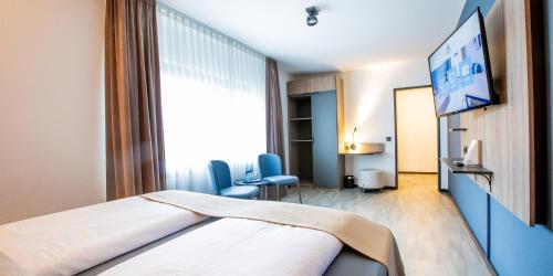 Hotel Das Augustinにあるテレビまたはエンターテインメントセンター